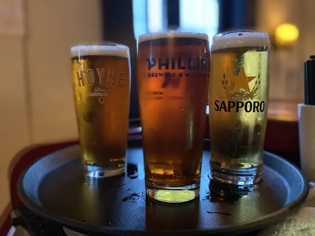 Three draught beers on a tray in the evening