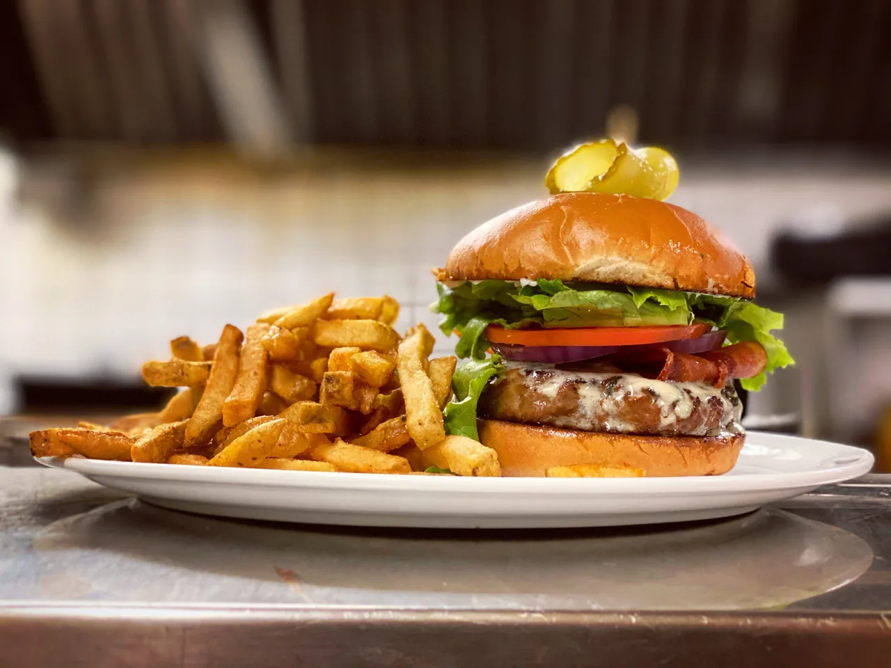 Beef burger stacked high with fries