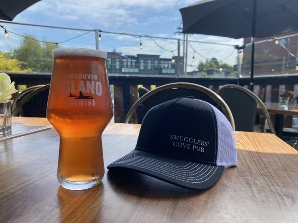 A pint and a Smugglers Cove cap on the patio table