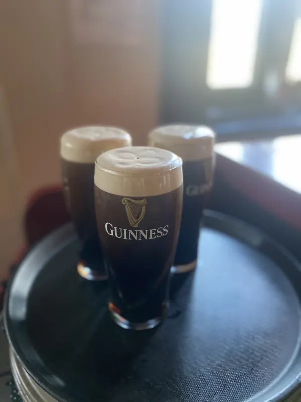 Two pints of Guinness settling on a tray