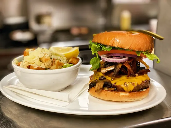 Double cheeseburger with a bowl of poutine