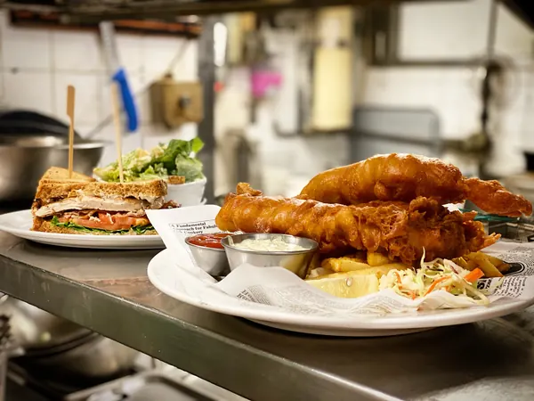 Club sandwich and fish and chips on the pass