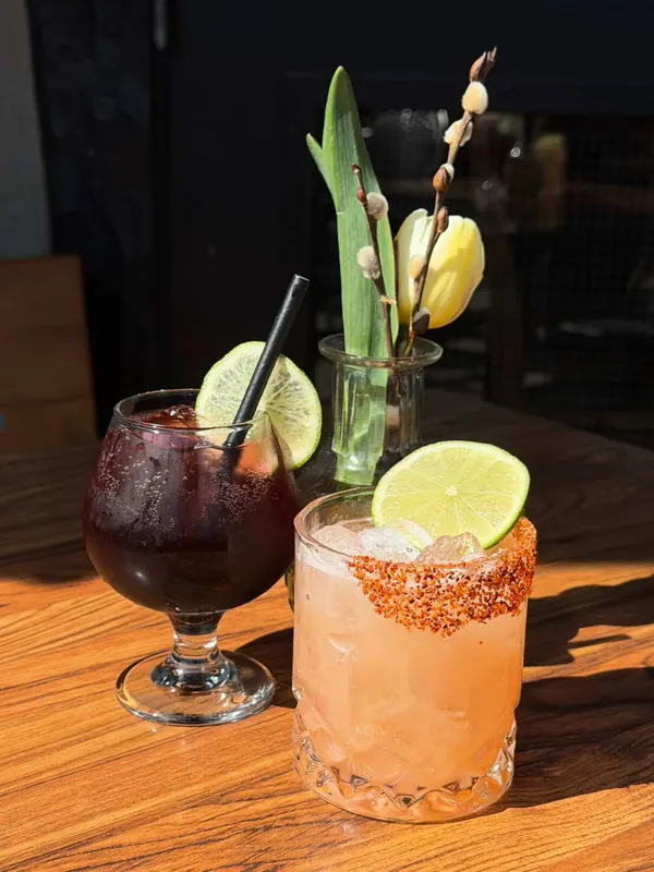 Two cocktails garnished with citrus