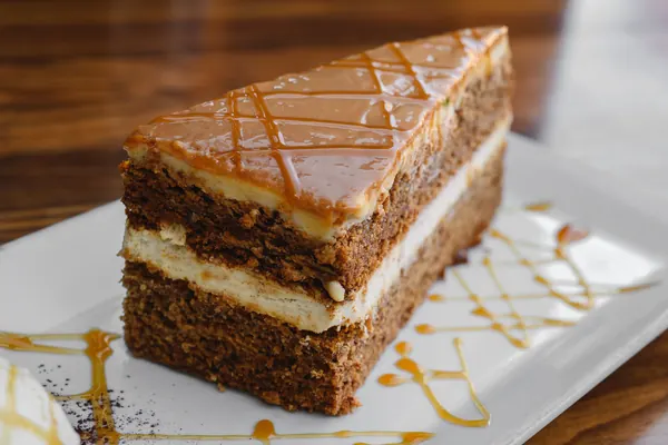 A slice of layered carrot cake