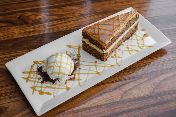 Carrot cake with ice cream and caramel