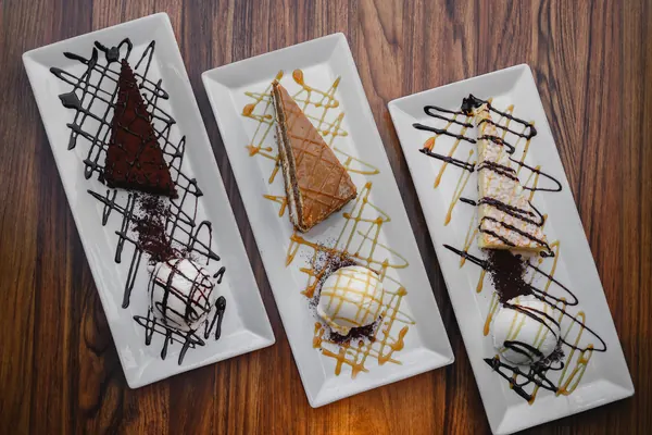 Three plated desserts drizzled with chocolate and caramel