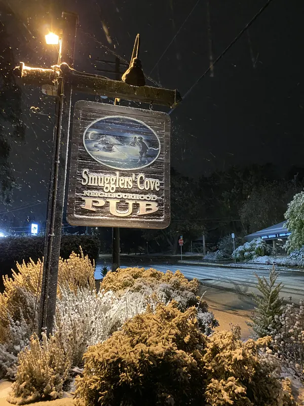 The Smugglers Cove sign lit up at night