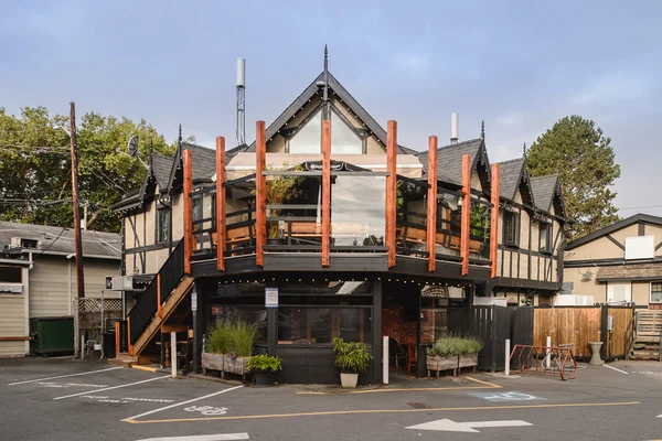 The Tudor-style front of Smugglers' Cove, string lights along the gables and deck