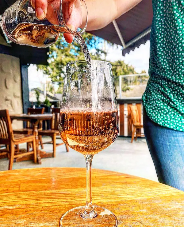 A glass of rose poured on the deck