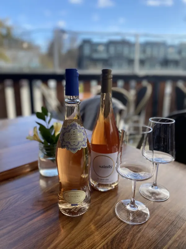 Rose and white wine with glasses on the patio